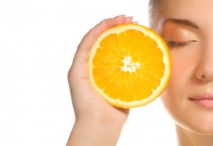 Beautiful girl with juicy orange